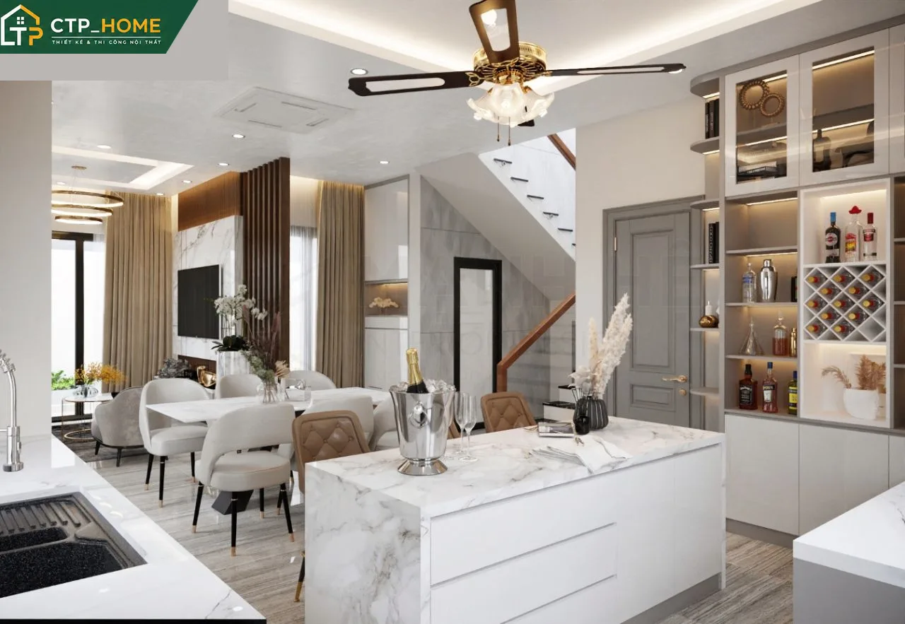 Bếp hiện đại nhà phố Long An với tủ bếp chữ L, mặt đá thạch anh và hệ thống hút mùi âm tủ